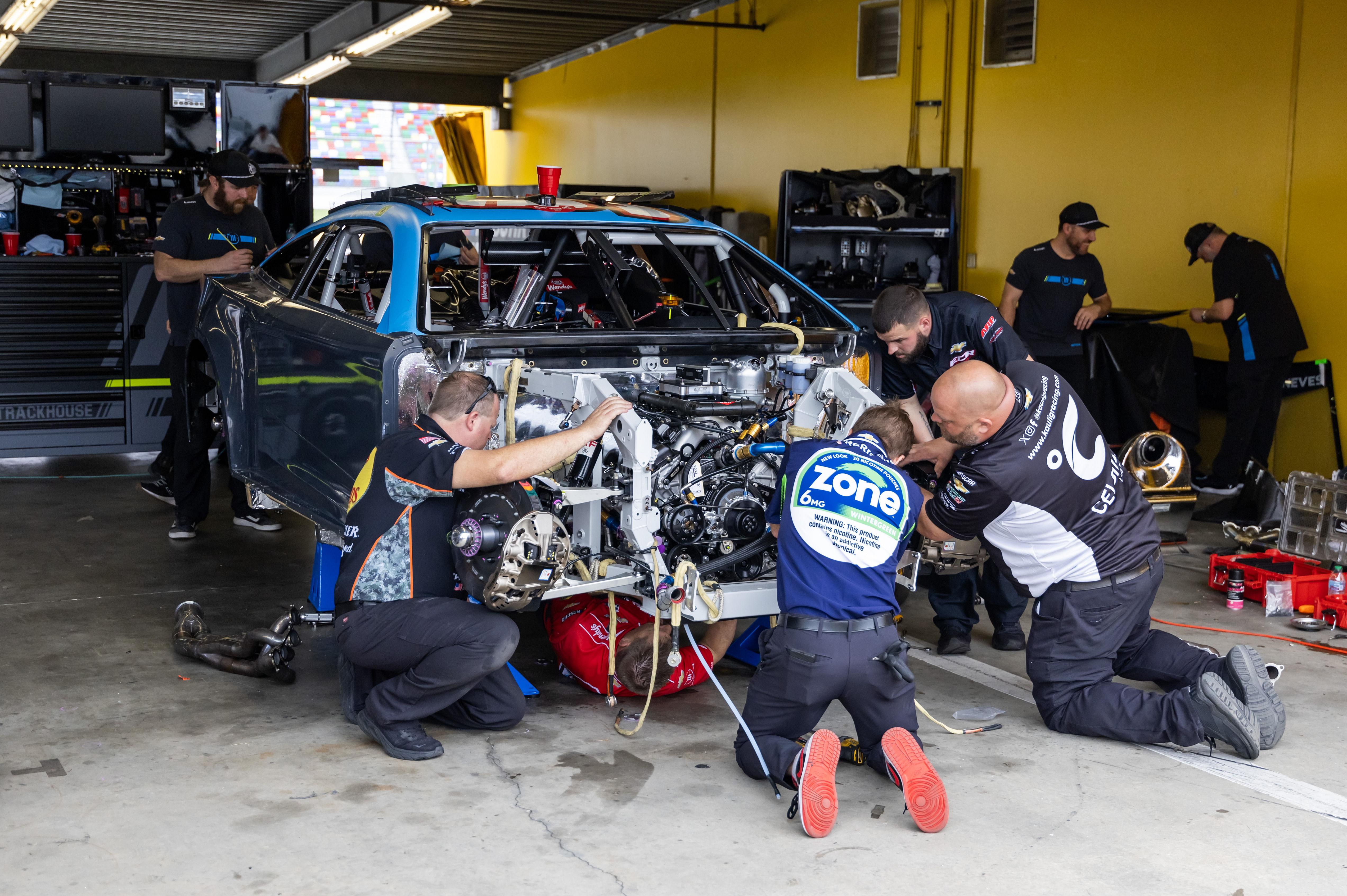 Trackhouse Racing crew work on the car of NASCAR Cup Series driver Helio Castroneves at Daytona 500. Source: Imagn